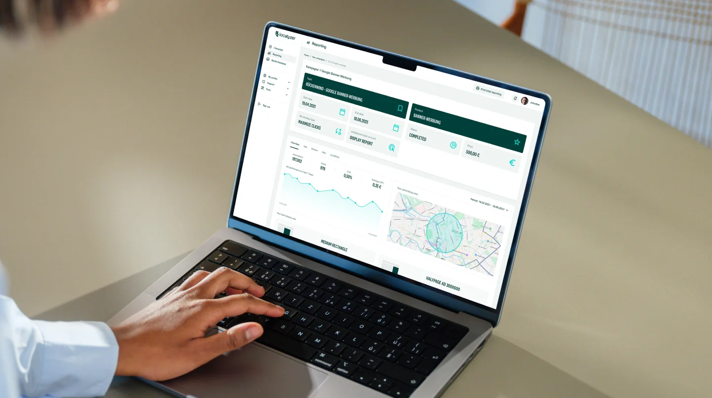 Person using a laptop to view the Localyzer dashboard with graphs and statistics.